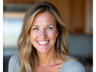 Smiling woman, Sarah L. (48), looking refreshed and energetic.